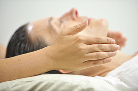 Client receiving Reiki at her throat (the throat chakra)